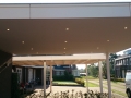Carport Veranda, Veranda Plaza, Glazen schuifwanden, terrasoverkapping, overkapping, buitenkamer, tuinkamer, houtkachel, lichtstraat, daklicht, balustrade, terrasverwarming, tuin, terras, houten vloer.