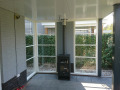 Veranda, Veranda Plaza, terrasoverkapping, overkapping, buitenkamer, tuinkamer, Carport houtkachel, lichtstraat, daklicht, Glazen schuifwanden, balustrade, hekwerk, terrasverwarming, tuin, terras, houten vlondervloer.