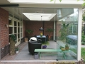 Veranda, Veranda Plaza, Glazen schuifwanden, terrasoverkapping, overkapping, buitenkamer, tuinkamer, Carport houtkachel, lichtstraat, daklicht, balustrade, hekwerk, terrasverwarming, tuin, terras, houten vloer.