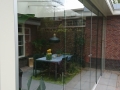 Veranda, Veranda Plaza, Glazen schuifwanden, terrasoverkapping, overkapping, buitenkamer, tuinkamer, Carport houtkachel, lichtstraat, daklicht, balustrade, hekwerk, terrasverwarming, tuin, terras, houten vloer.